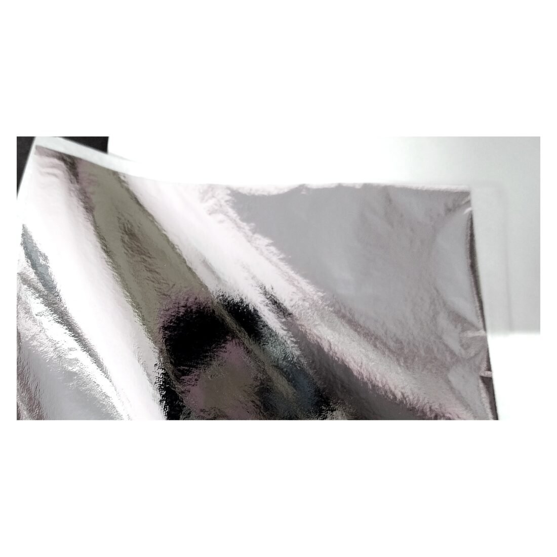 Close-up of silver glossy imitation leaf foil shine and texture