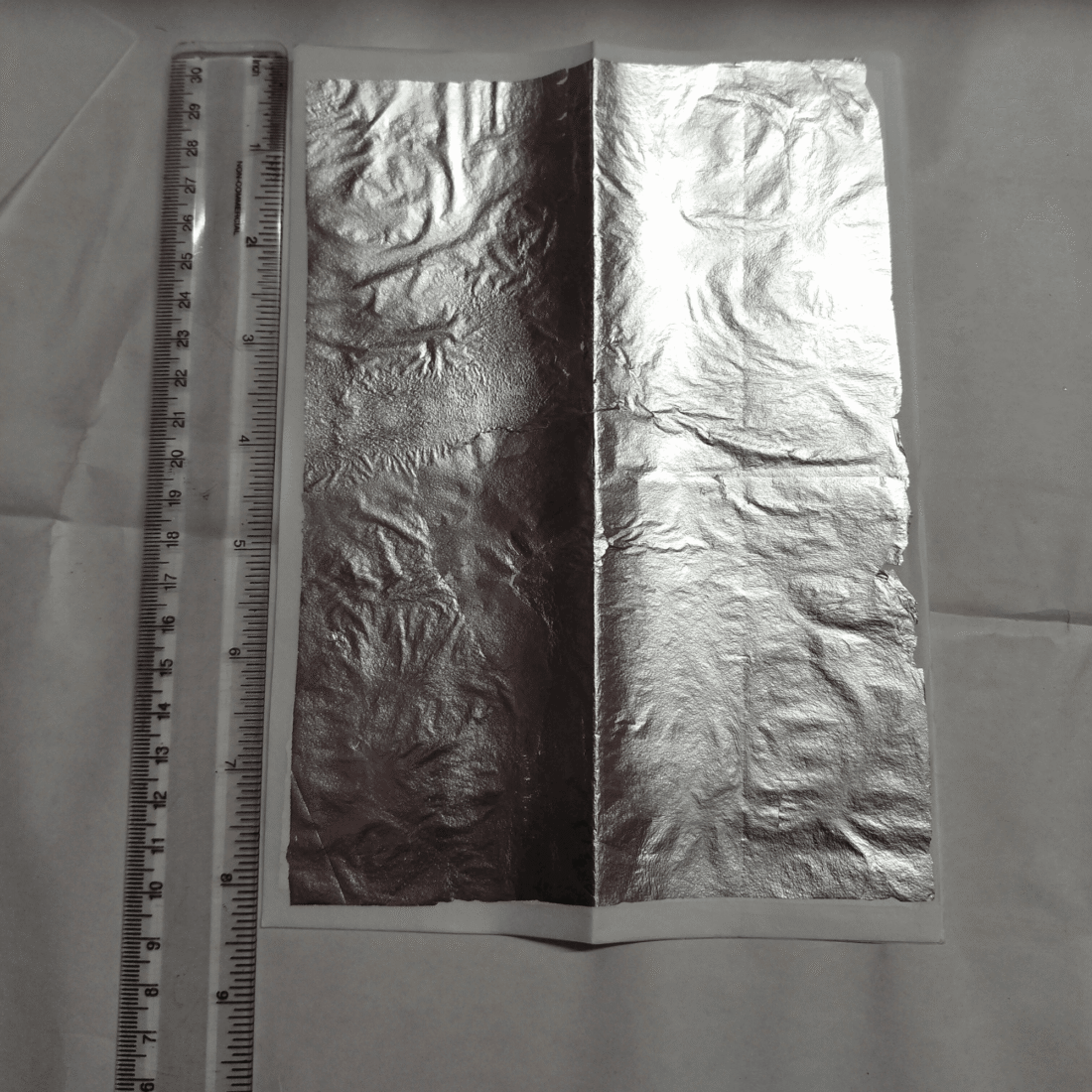 Silver leaf sheet 6x8 inch placed next to a measuring scale