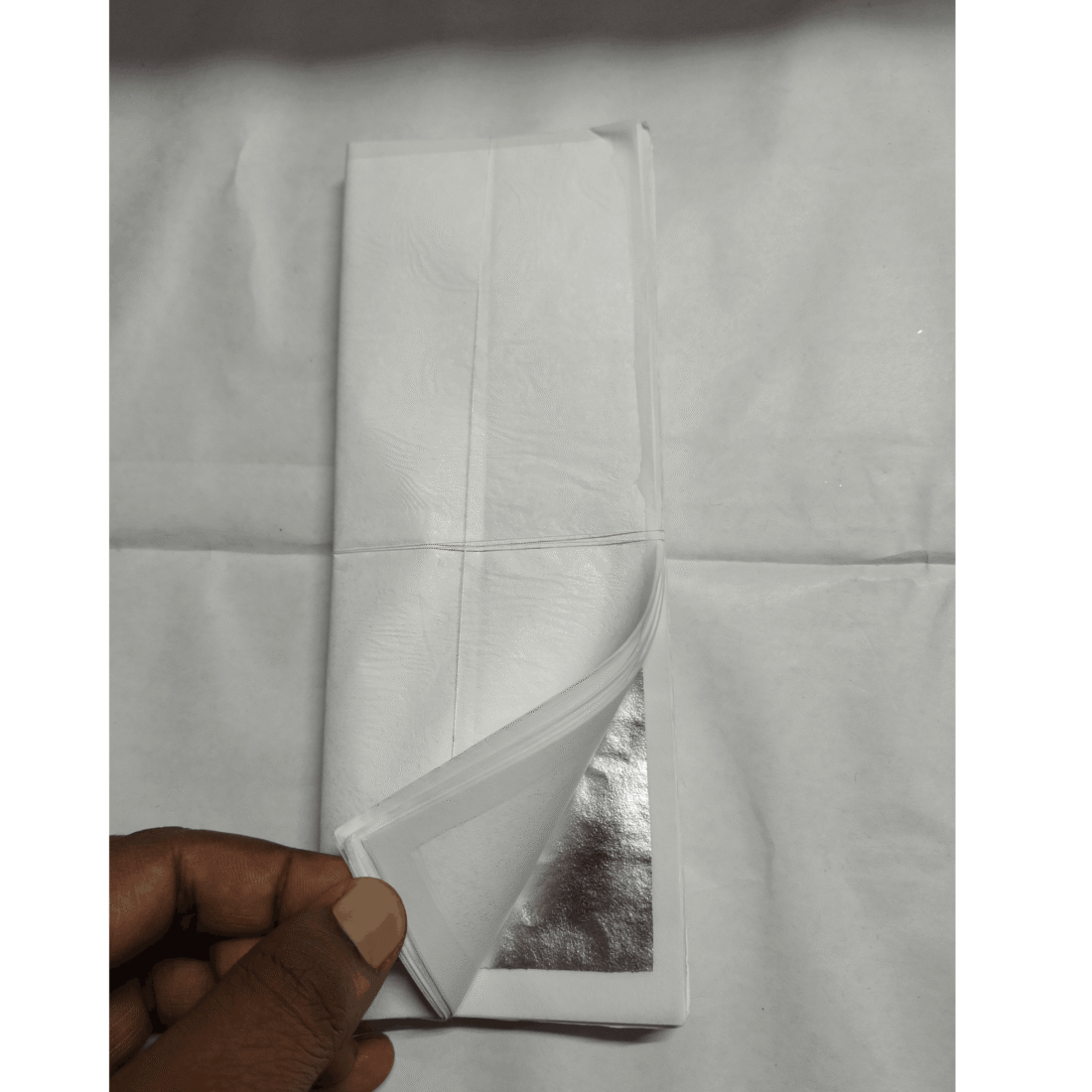 Silver leaf booklet with tissue paper between each sheet
