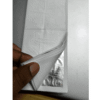 Silver leaf sheet lifted from tissue interleaved booklet by hand