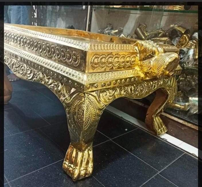 Gold leafing on carved wooden singhasan table with lion legs