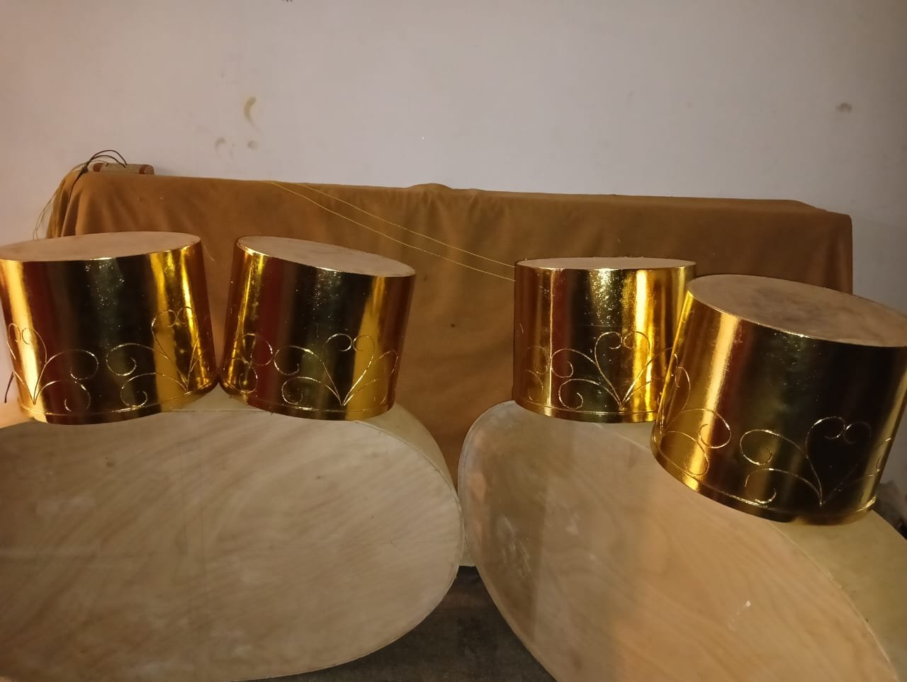 Round side tables finished in gold leaf with hand engraved design