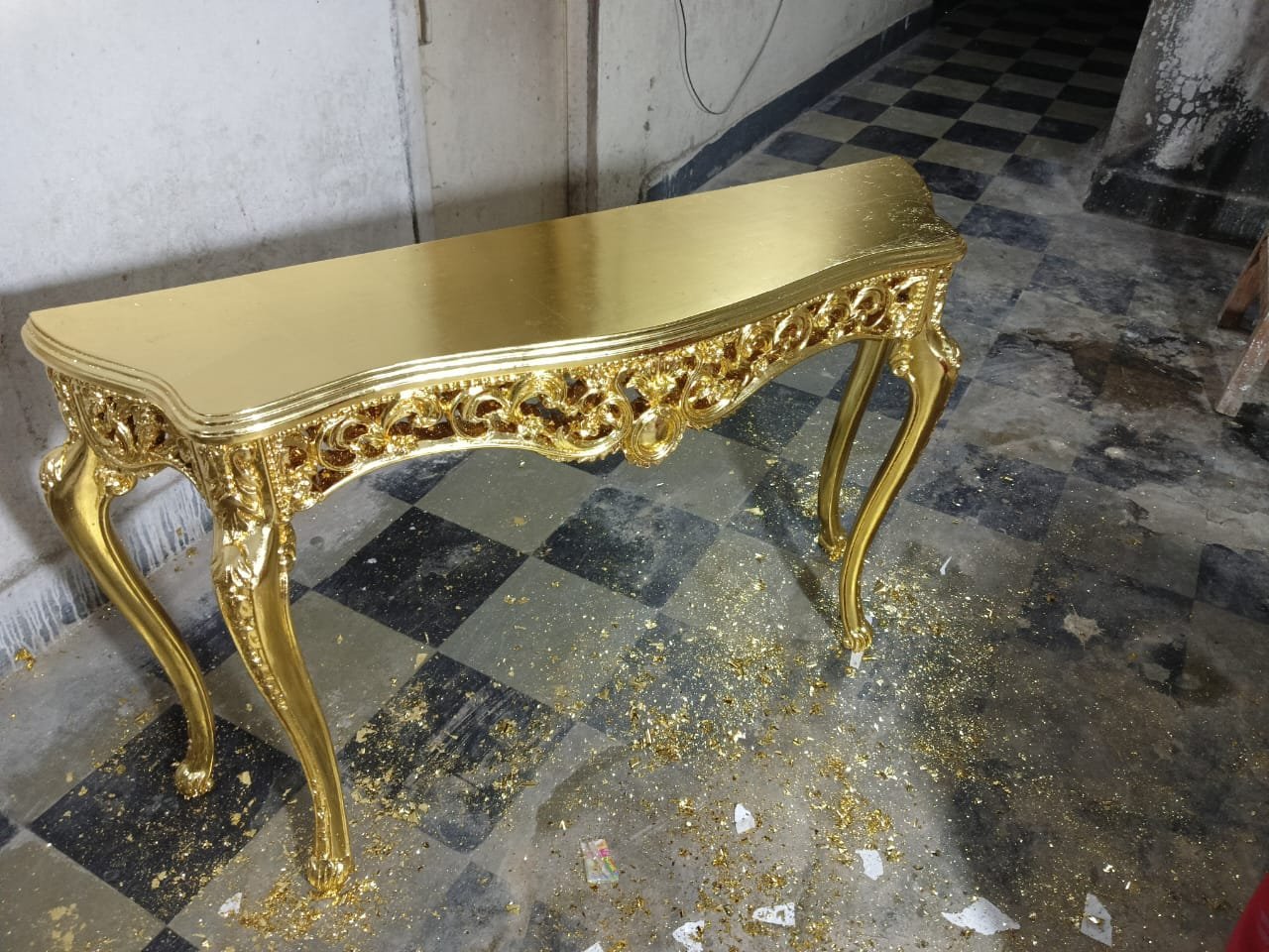 Carved wooden console table finished with gold leaf by Sumera Warq