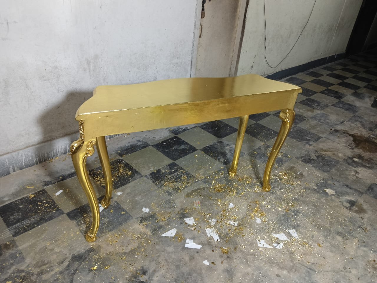 Console table during gold leaf finishing at Sumera Warq workshop