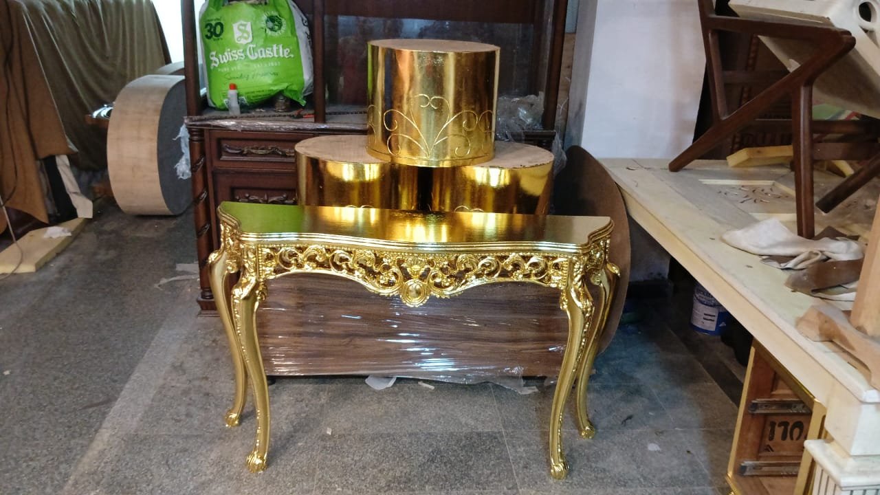 Gold leafed console table with round side tables by Sumera Warq