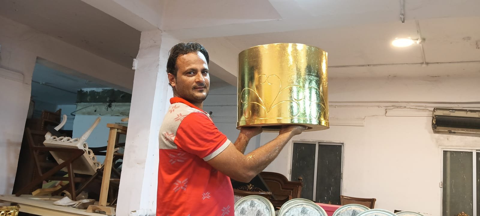 Karigar holding a hand gold leafed round table