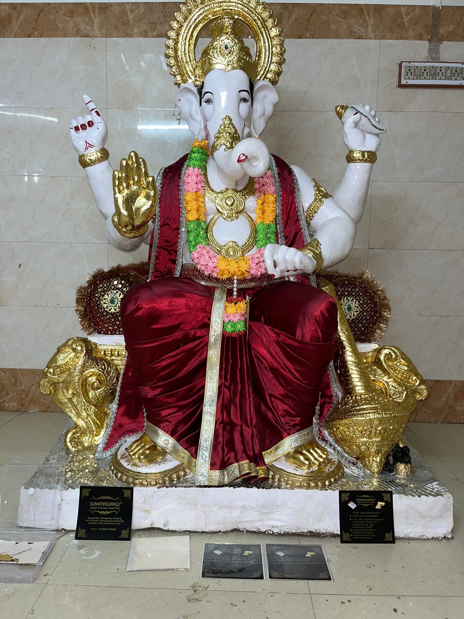 Gold leafing on small Ganesh idol hands and crown by Sumera Warq