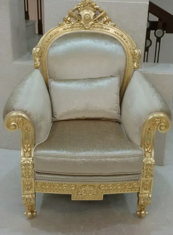 Carved armchair frame finished in gold leaf with upholstery