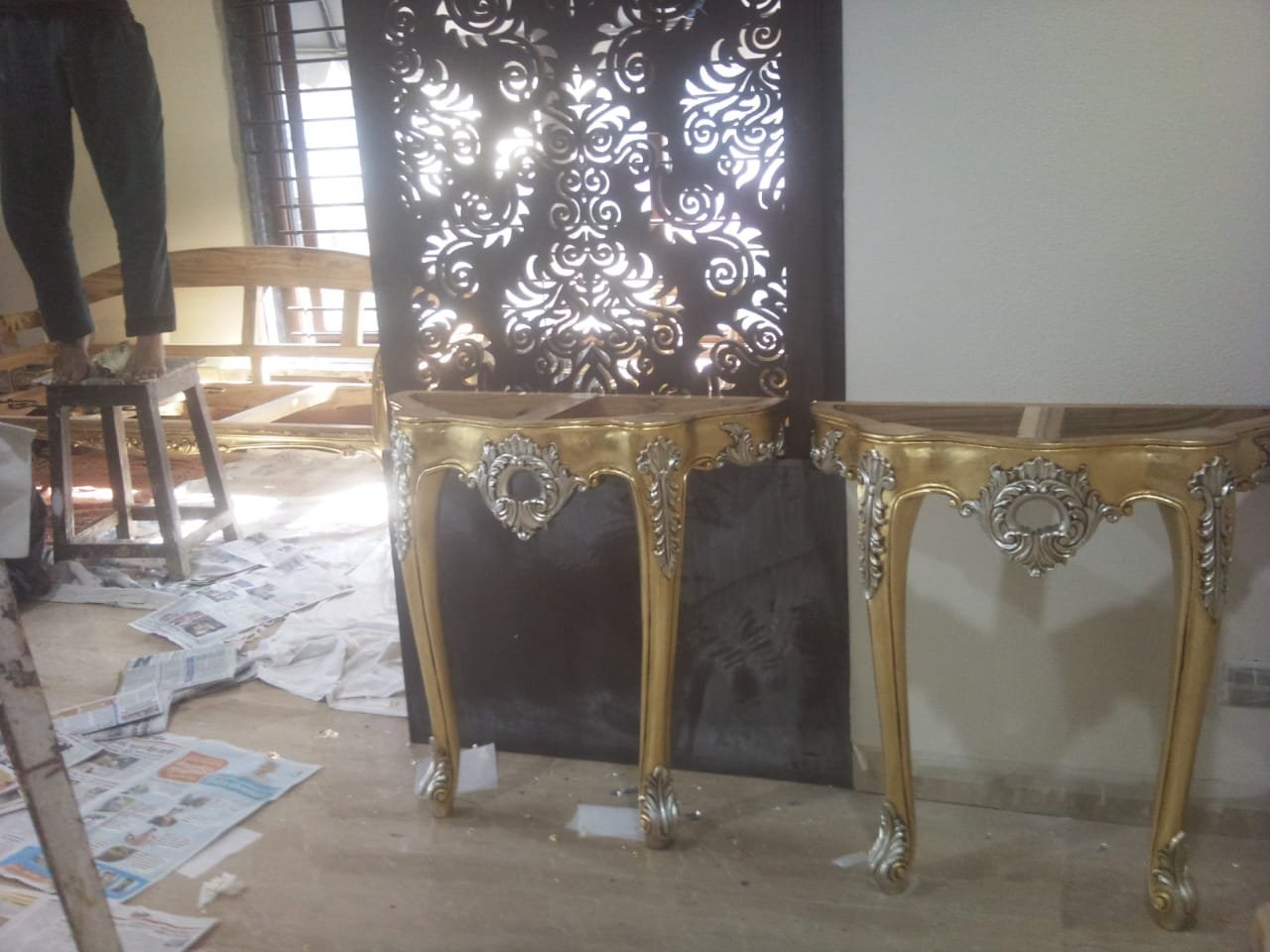 Console tables finished in combined gold and silver leaf