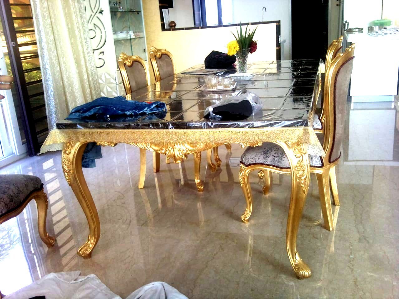 Gold leafing on carved dining table and chairs with marble top