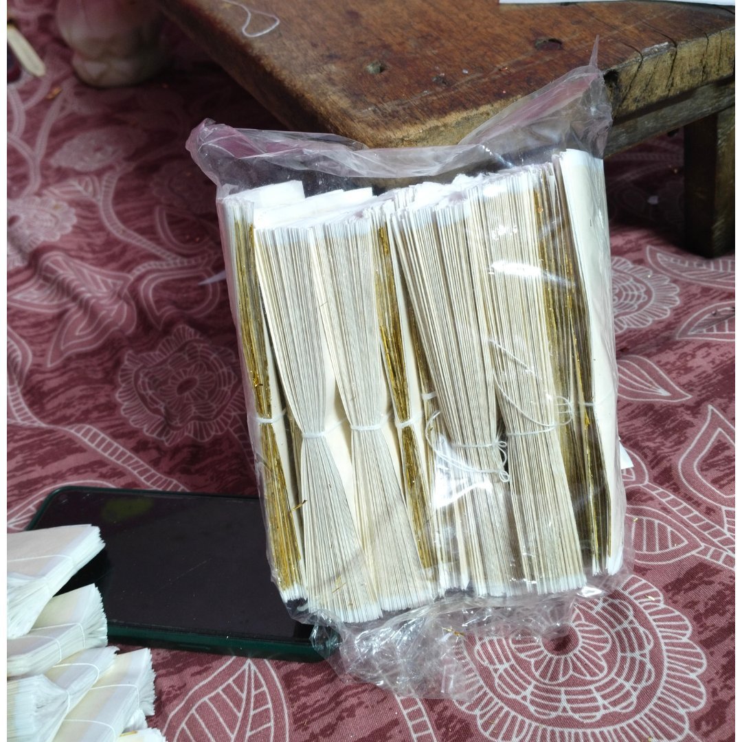 Bulk pack of gold leaf foil sheets wrapped in protective plastic