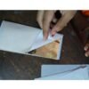 Gold leaf foil sheets gaddi pack being opened by hand