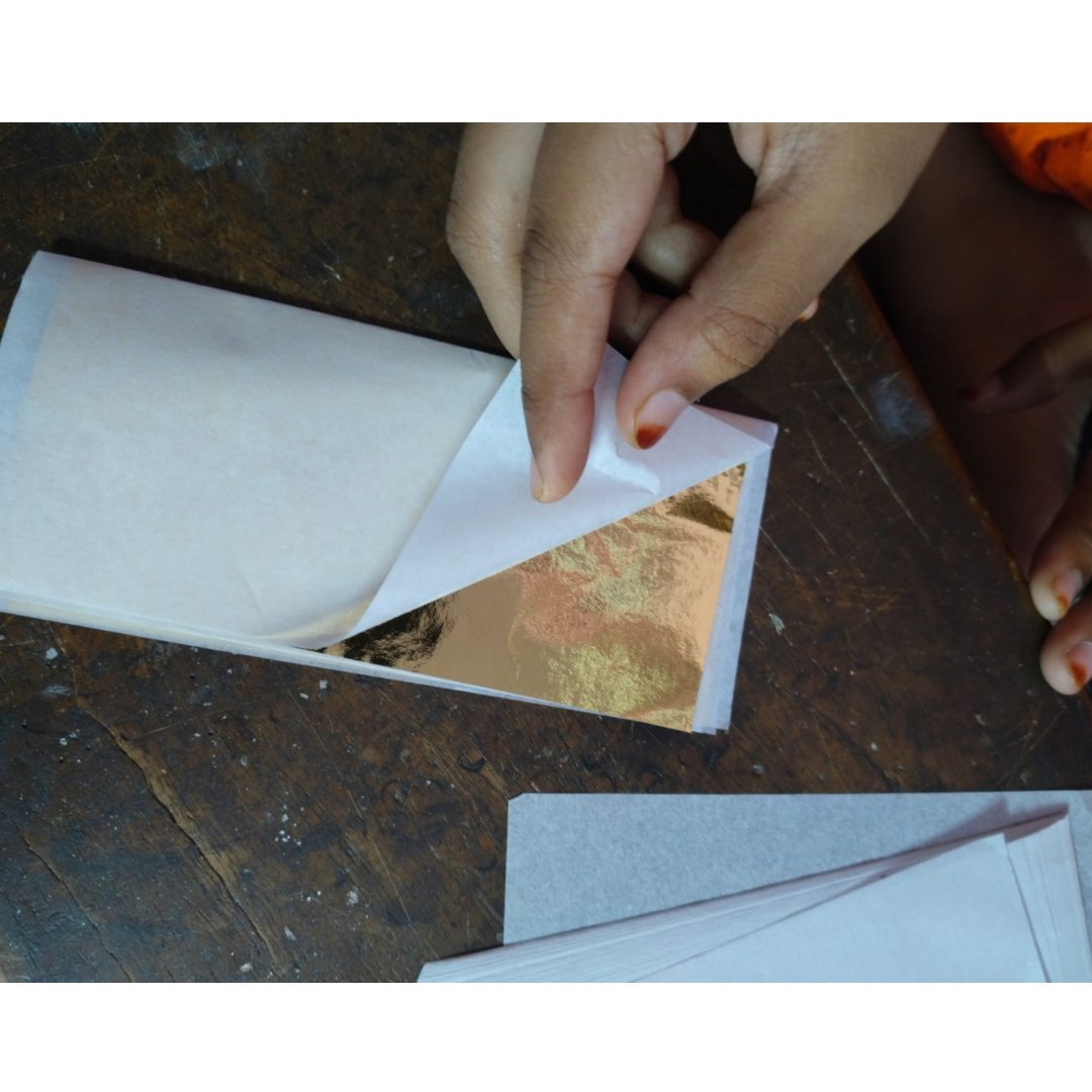 Gold leaf foil sheets gaddi pack being opened by hand