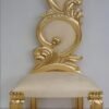 Gold leaf foil sheets applied on a carved wooden chair
