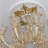 Gold leaf foil sheets applied on a carved ceiling rose