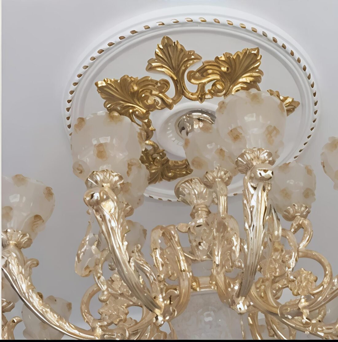Gold leaf foil sheets applied on a carved ceiling rose