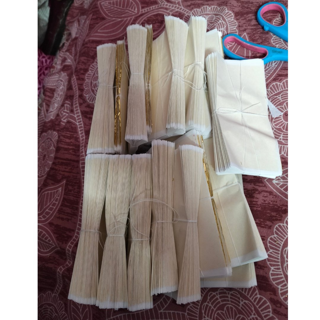 Tied bundles of gold leaf foil sheets 14x14 cm