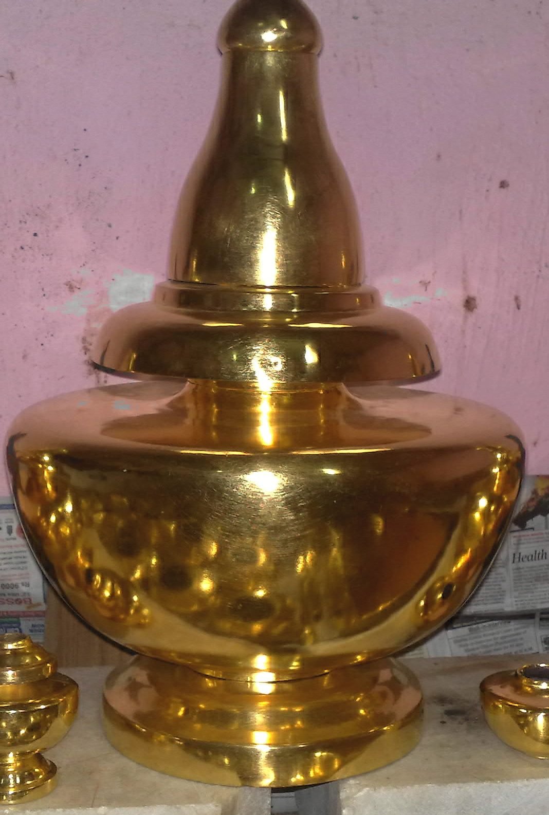 Close-up finish of gold leaf on a large mandir kalash