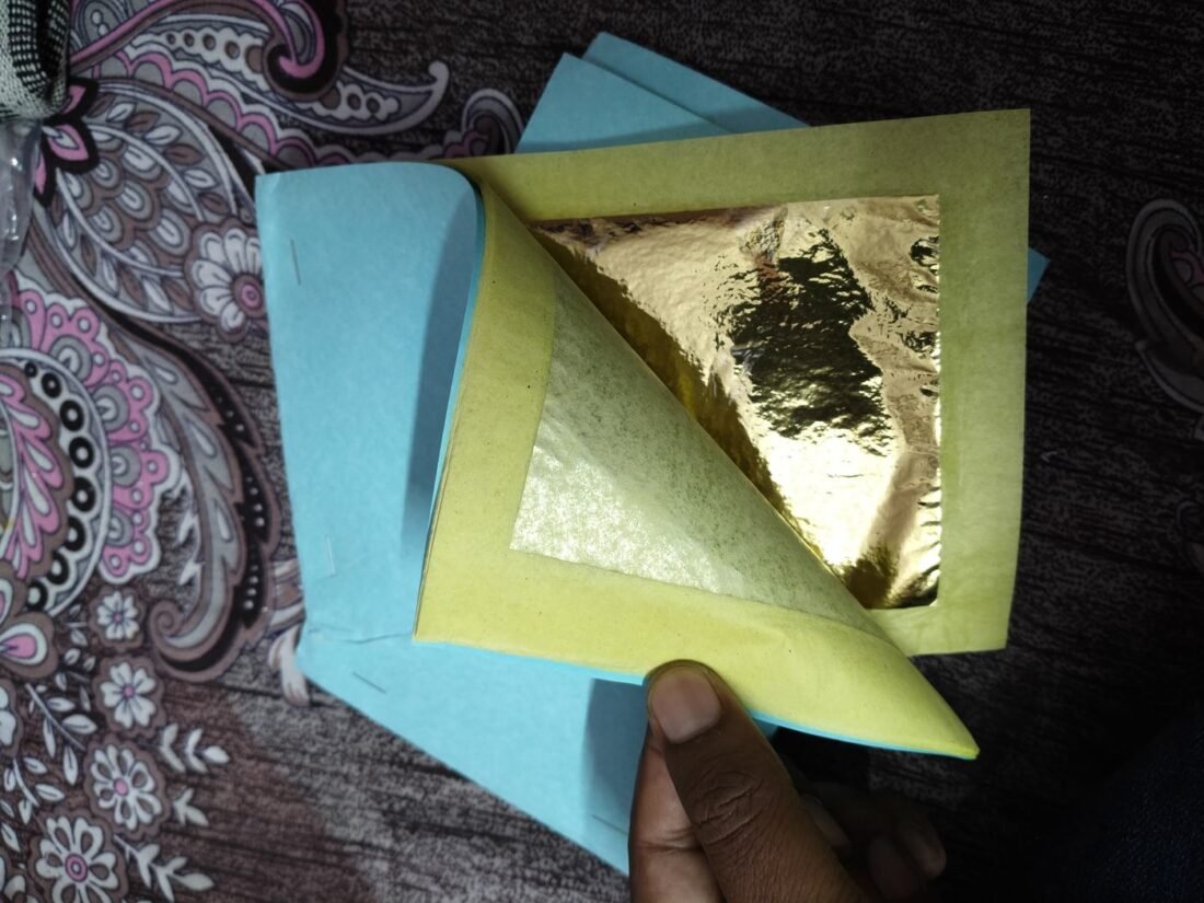 Tanjore painting gold foil sheet held in hand