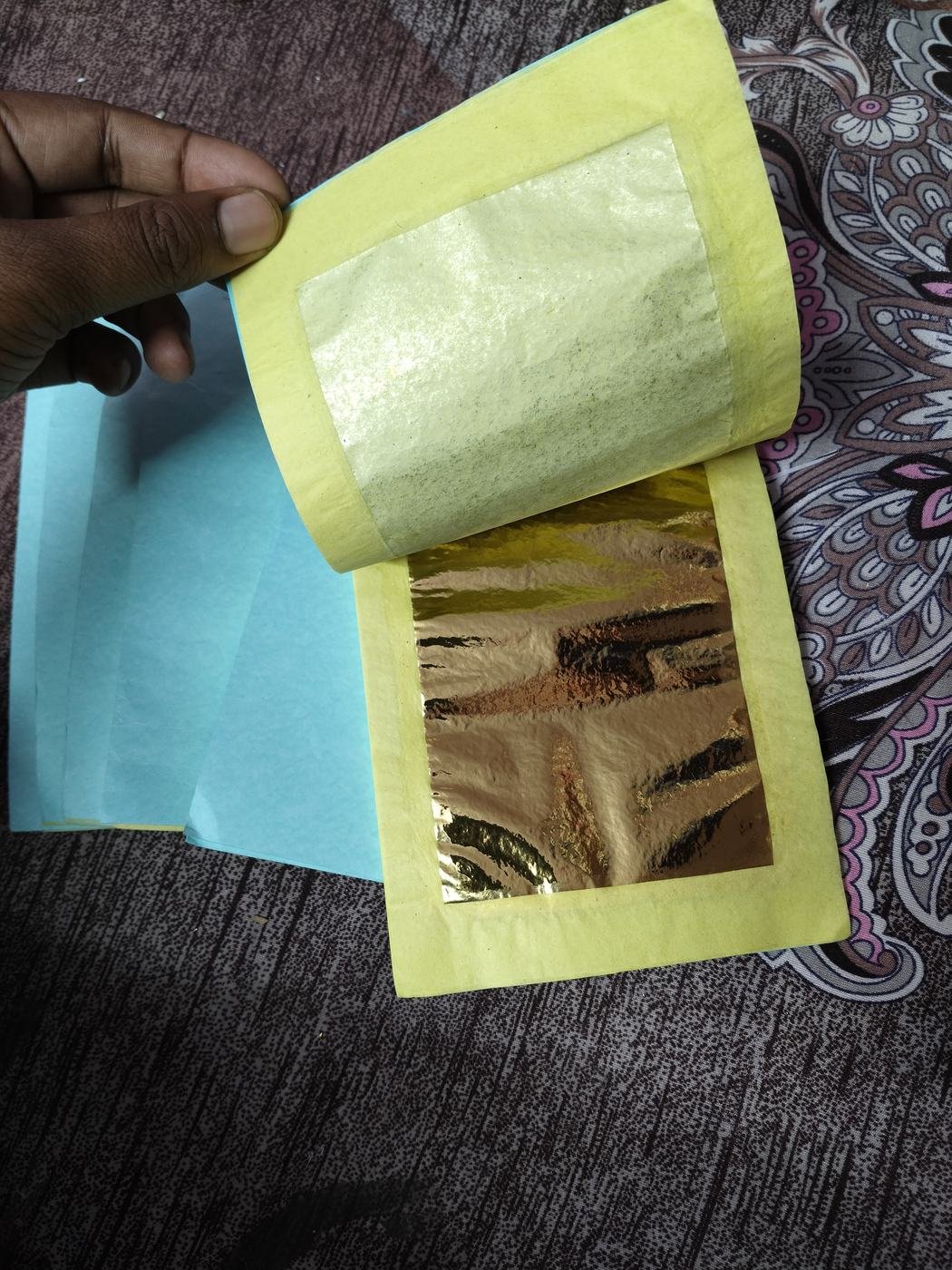 Tanjore painting gold foil sheet open on tissue paper Tanjore painting gold foil sheet open on tissue paper