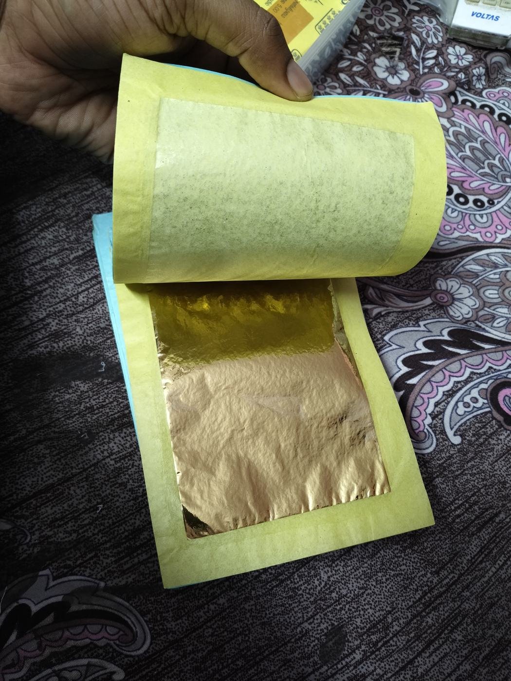 Tanjore painting gold foil book with tissue interleaving Tanjore painting gold foil book with tissue interleaving