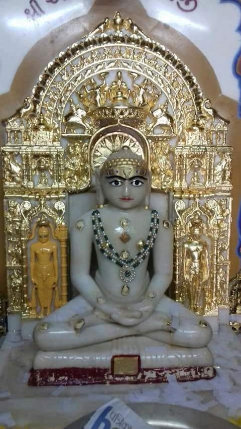 White marble murti with a gold leafed parikar and mukut