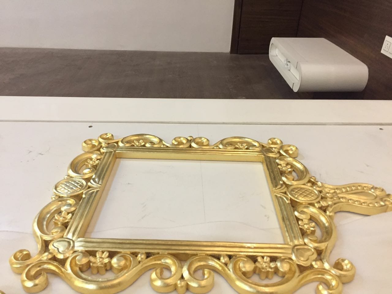 Hand carved mirror frame finished in gold leaf